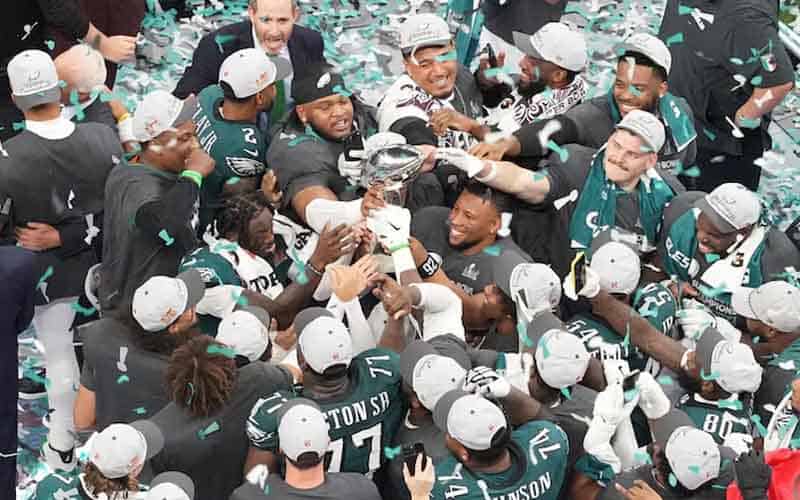 Phildelphia Eagles teammates hoisting the Lombardi Trophy at SB LIX