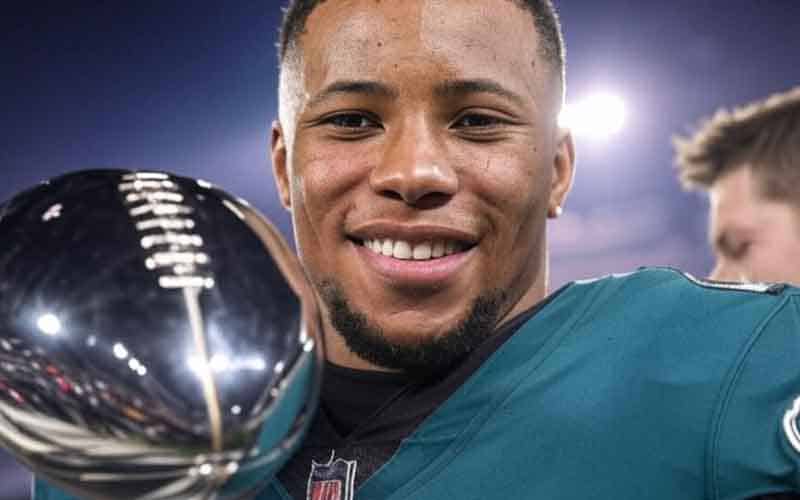 Saquon Barkley of the Philadelphia Eagles holding a Super Bowl MVP Trophy